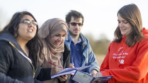Visitors looking at maps of Wicken Fen National Nature Reserve, Cambridgeshire.